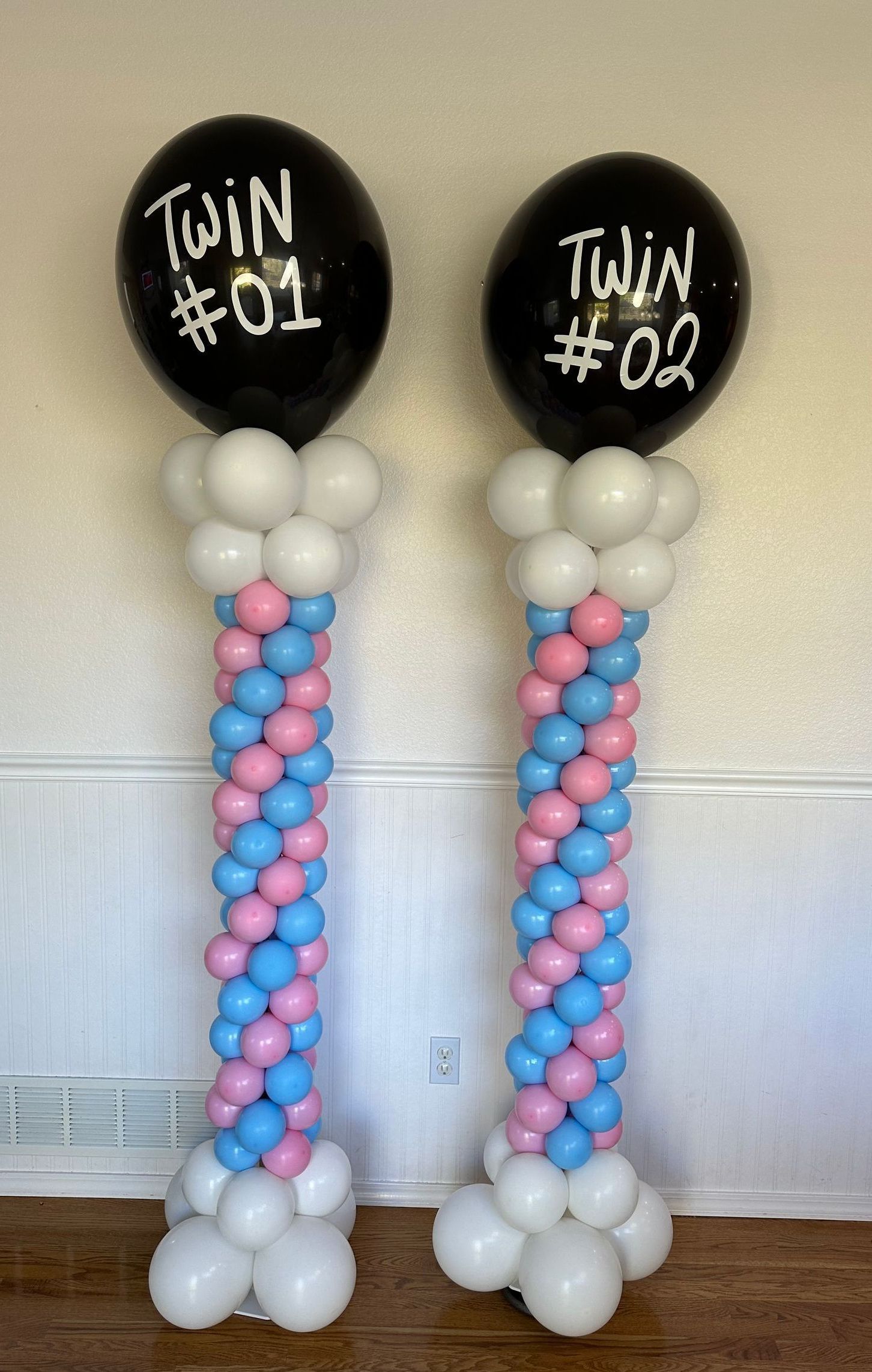 Two balloon columns, each with a black