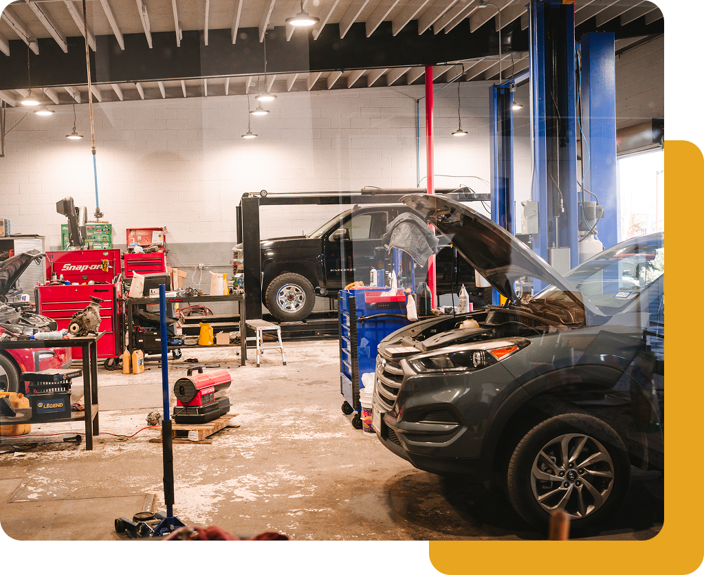 Inside a Mango Automotive shop with vehicles in the service bays