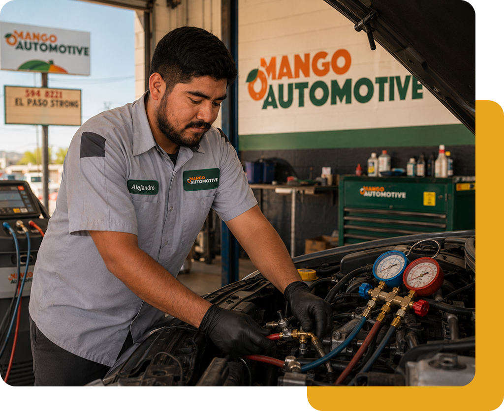 Mechanic in gray shirt works on car engine at Mango Automotive shop