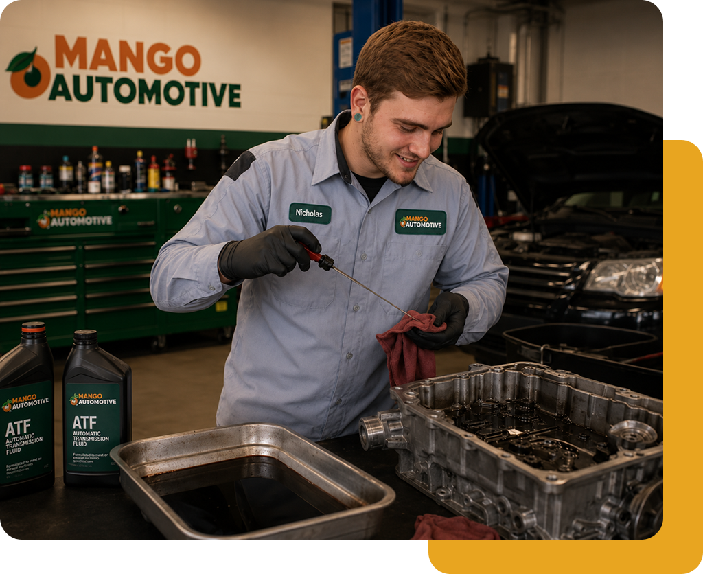 Mechanic in gray uniform checks oil in an auto shop with Mango Automotive signs and tools nearby