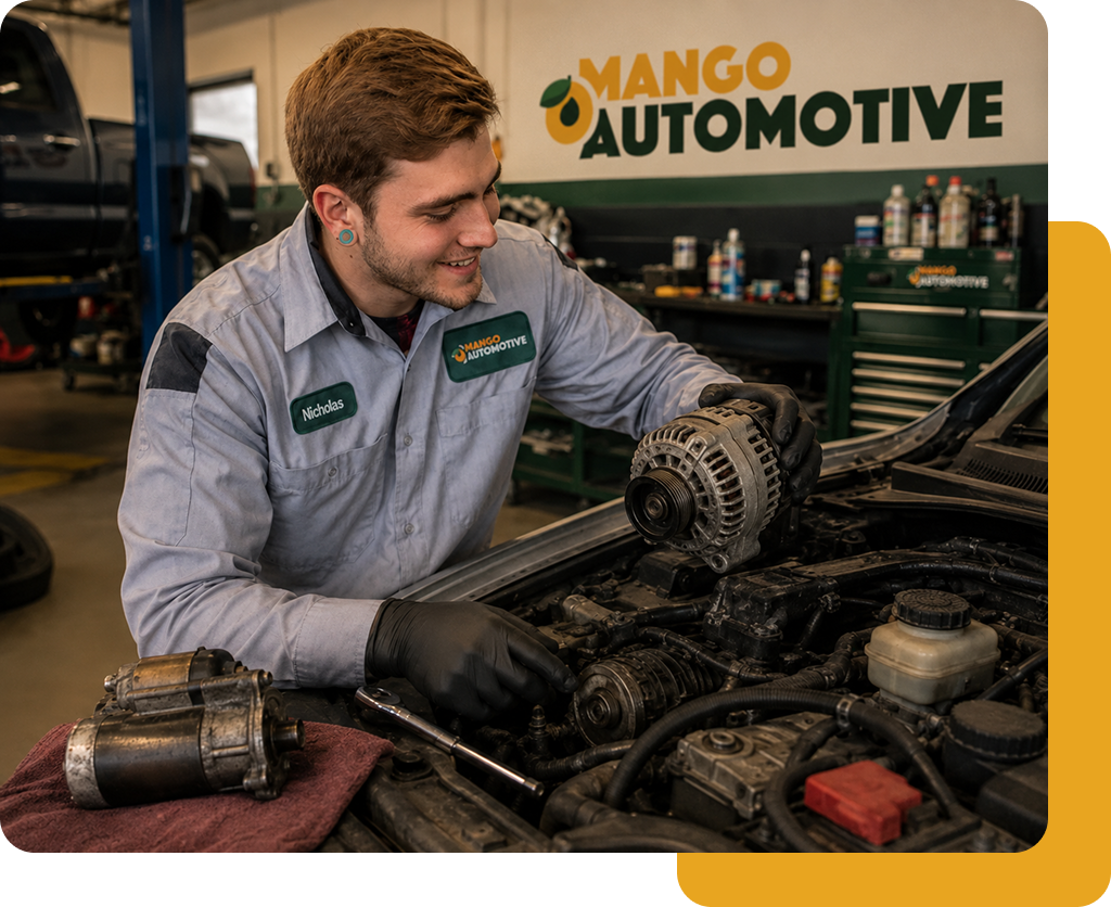 Mechanic in gray shirt inspecting an alternator in a Mango Automotive shop, with engine parts on the bench