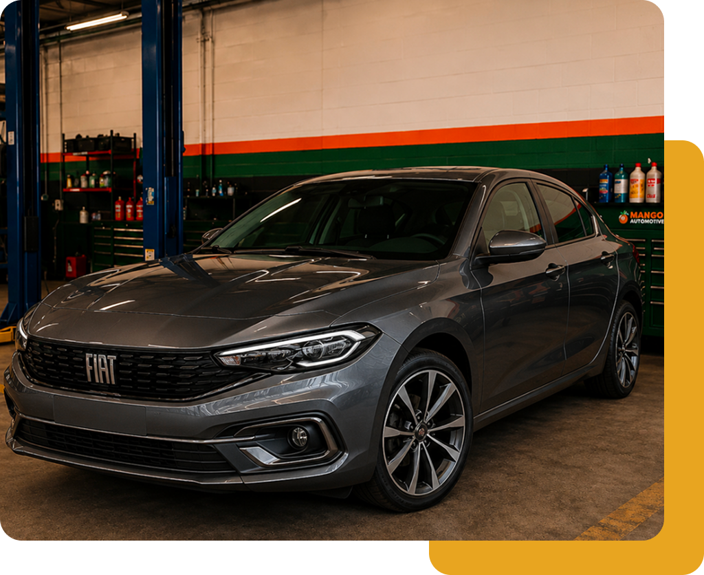 Gray Fiat sedan parked in a garage, front-left view with orange and green wall stripes