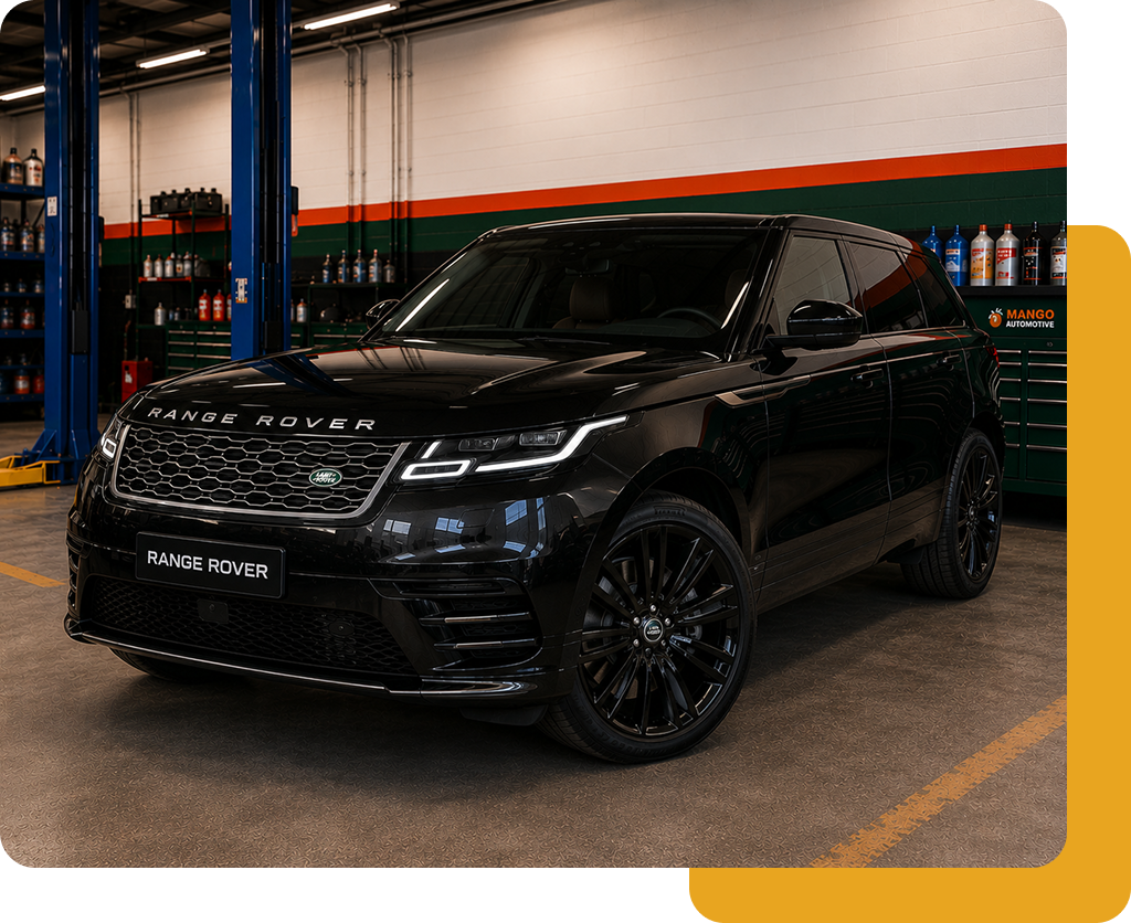 Black SUV in a garage, parked under bright lights with orange and green wall stripes.