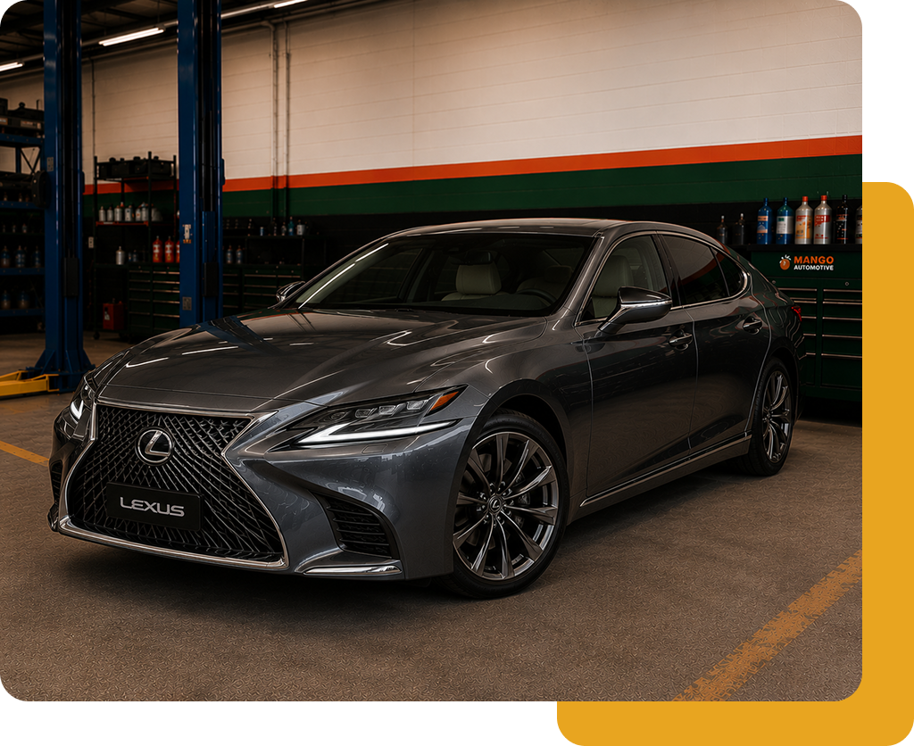 Dark gray Lexus sedan parked in a garage, front three-quarter view