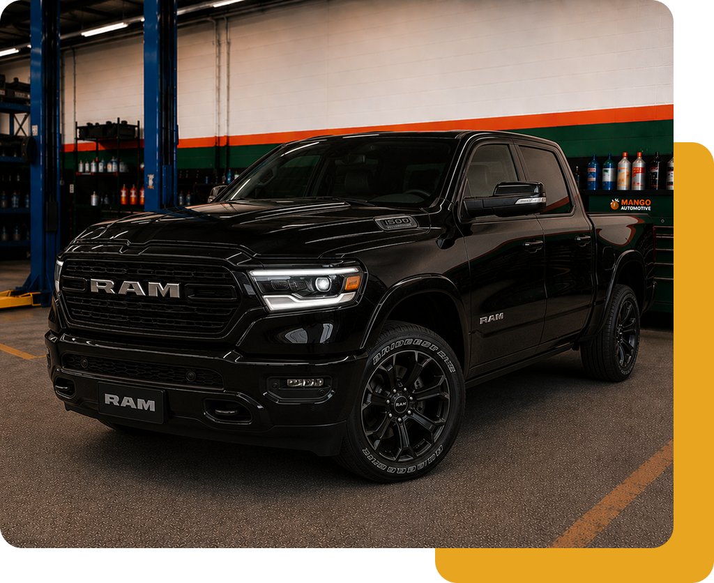 Black RAM pickup truck parked indoors in a garage or showroom.