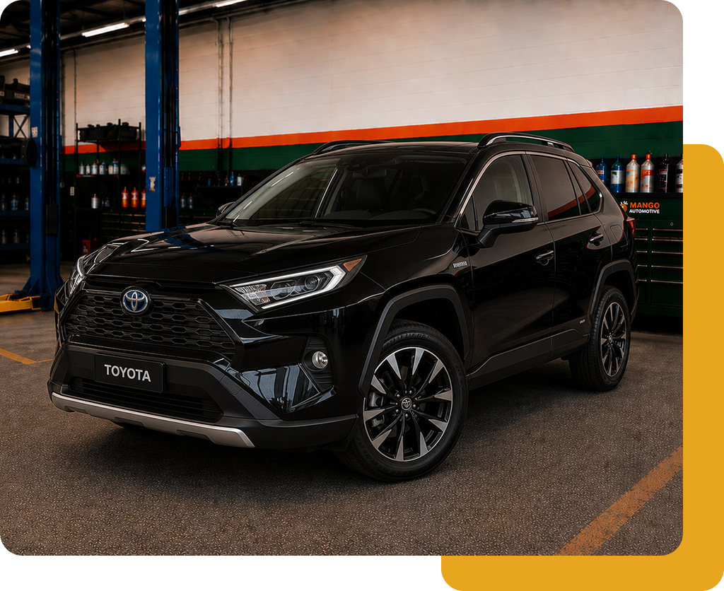 Black Toyota SUV parked indoors in a showroom or garage, viewed from the front-left.
