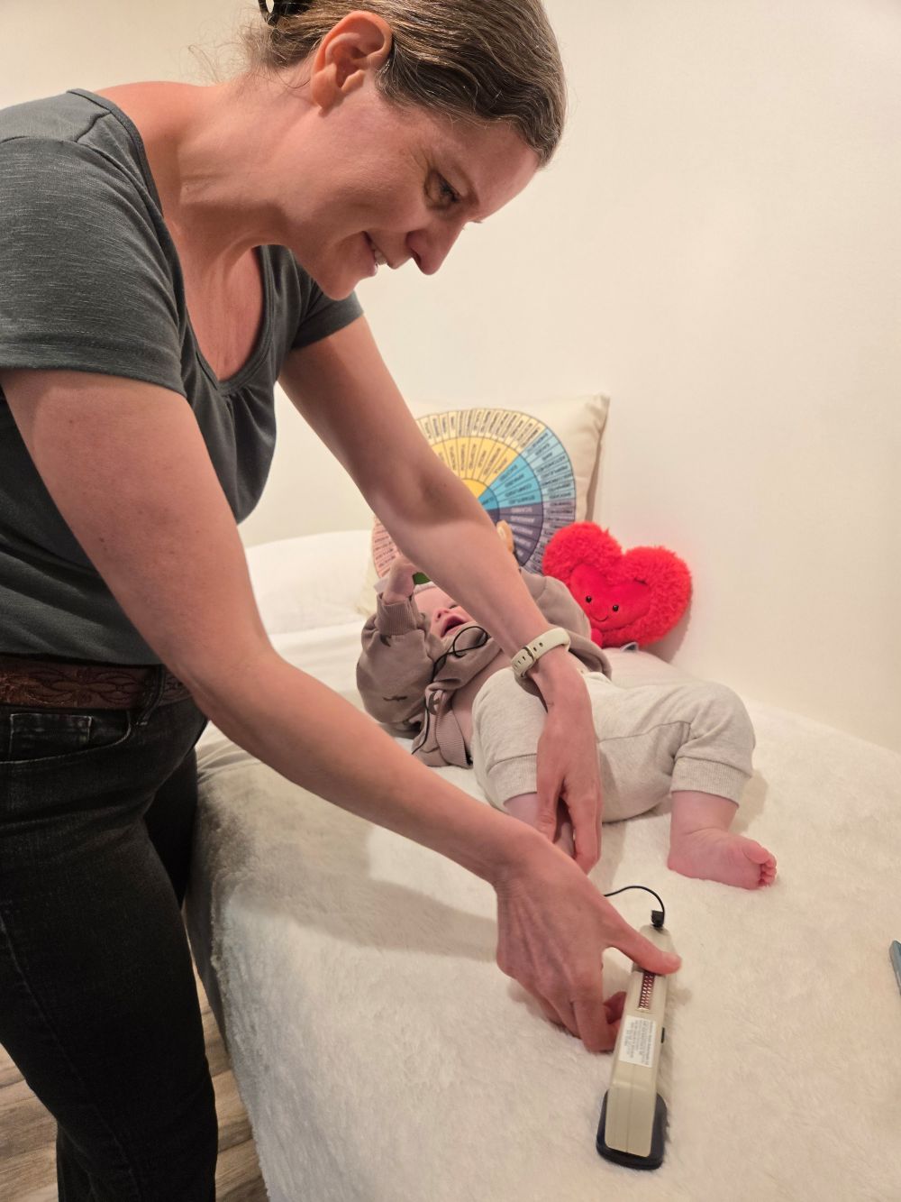 Woman helping a child with needleless acu-therapy