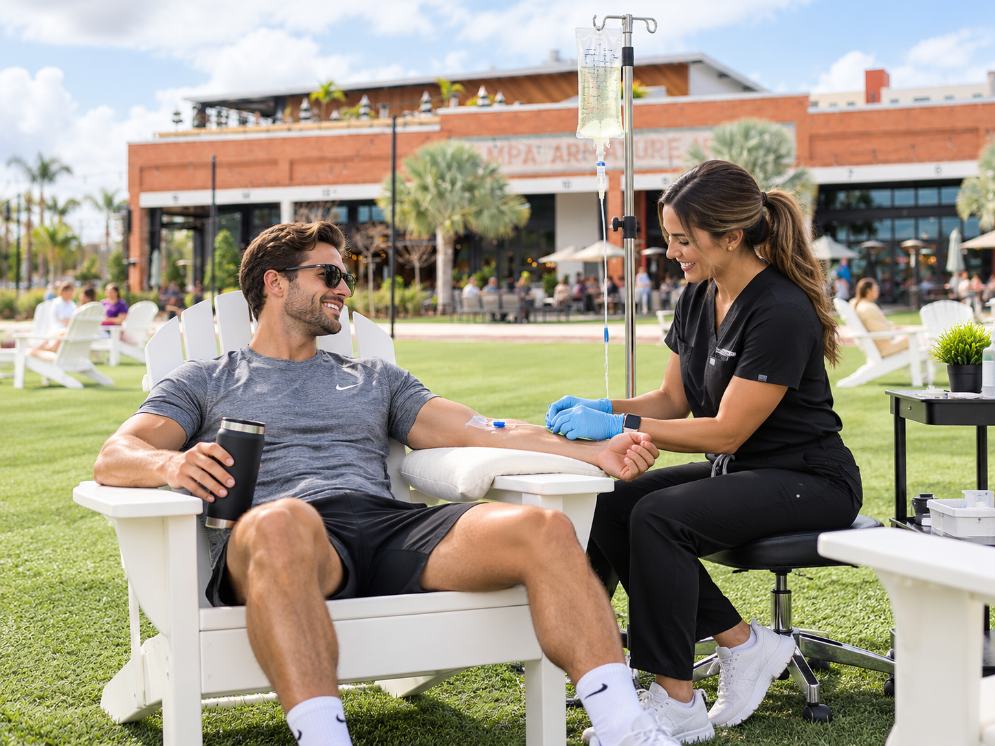 Nurse giving a man an IV vitamin drip on the lawn at Armature Works in Tampa
