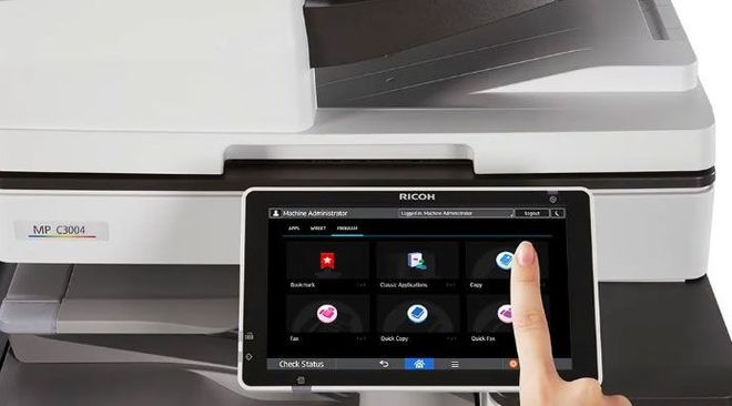 A person is using a tablet to control a printer.