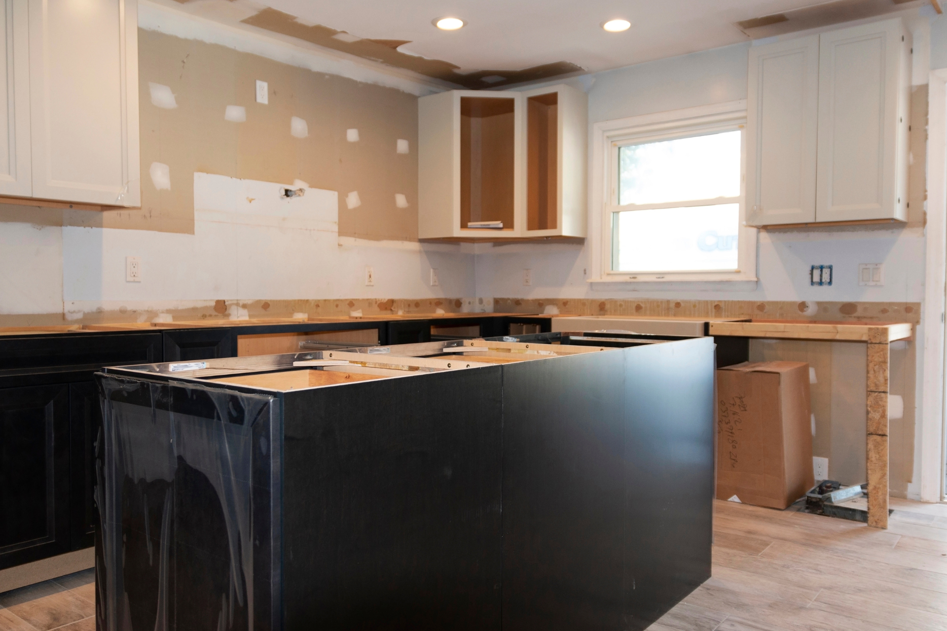 Hammond kitchen under renovation with partially installed cabinets and a center island.