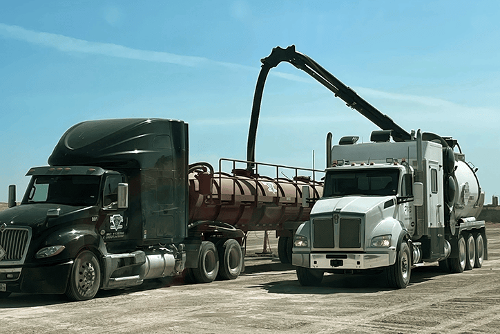 Rear and side view of parked water tanker truck.