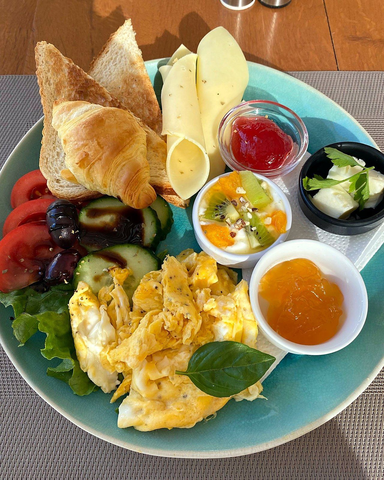 Breakfast plate with croissant, toast, scrambled eggs, cheese and homemade jam at Villa Karina, Skiathos