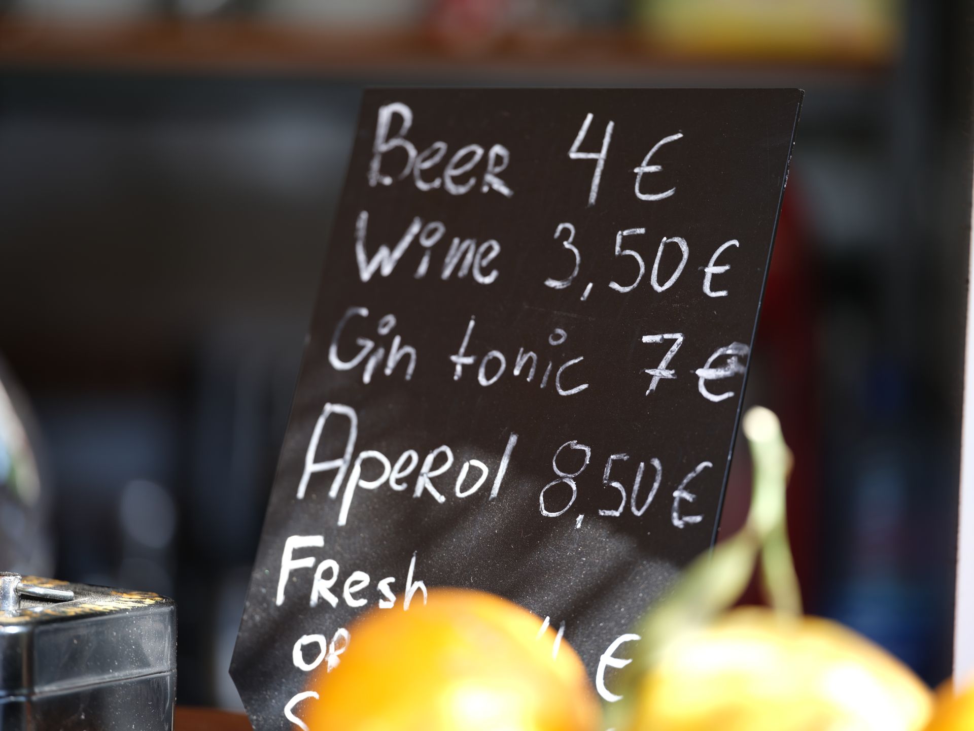 A chalkboard with beer wine gin tonic and aperol written on it