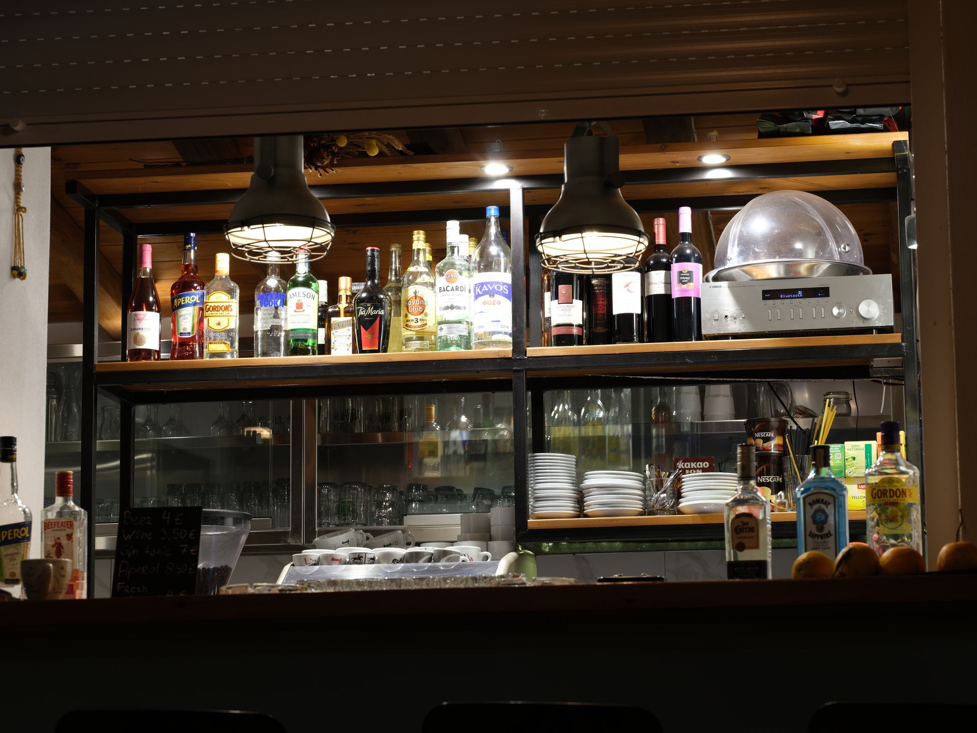Bottles of liquor are lined up on shelves in a bar