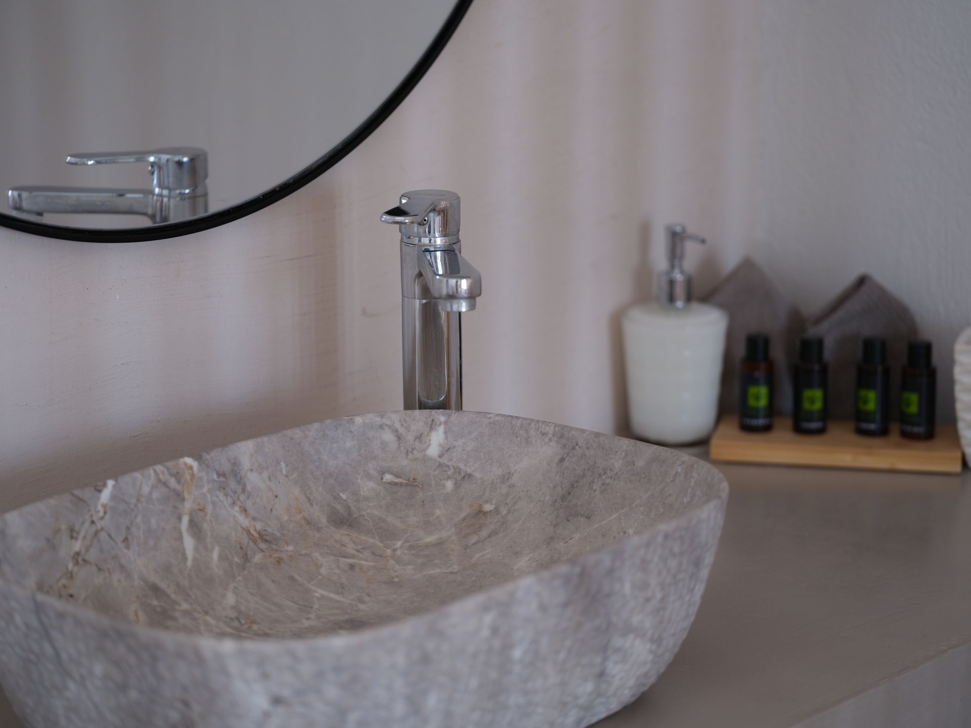 A bathroom sink with a faucet and a mirror.