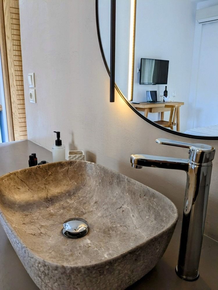 A bathroom sink with a faucet and a mirror