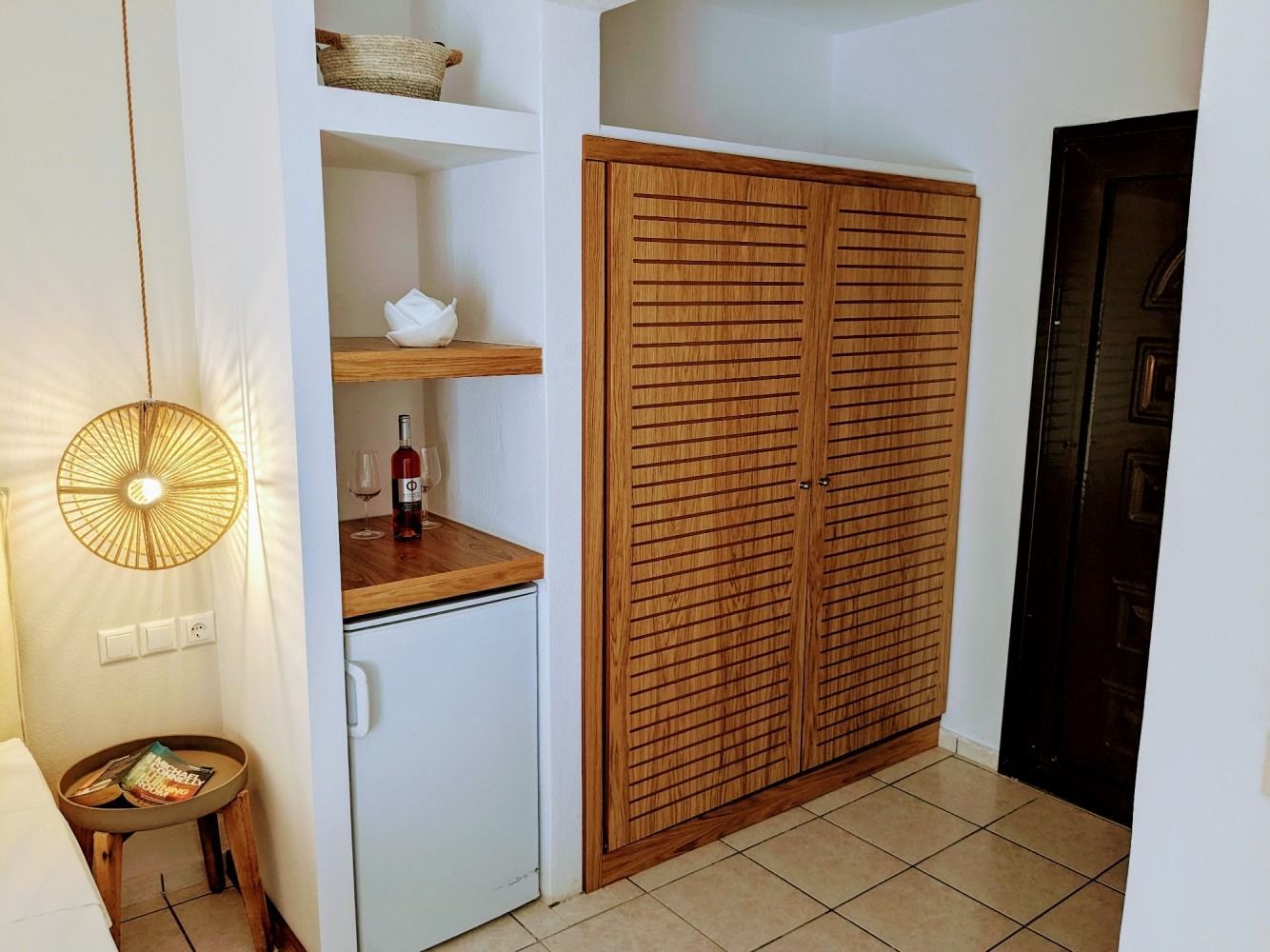 There is a bottle of wine on the counter in the closet.