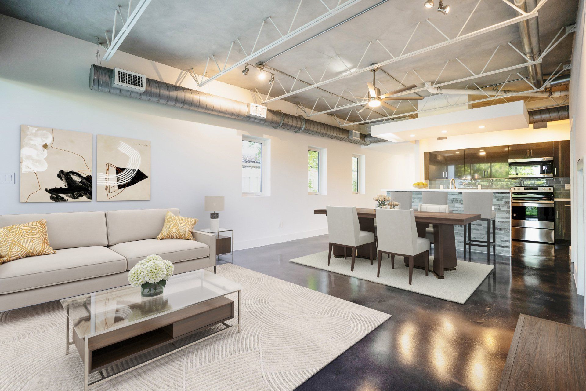a living room with a couch , coffee table , chairs and a dining table .