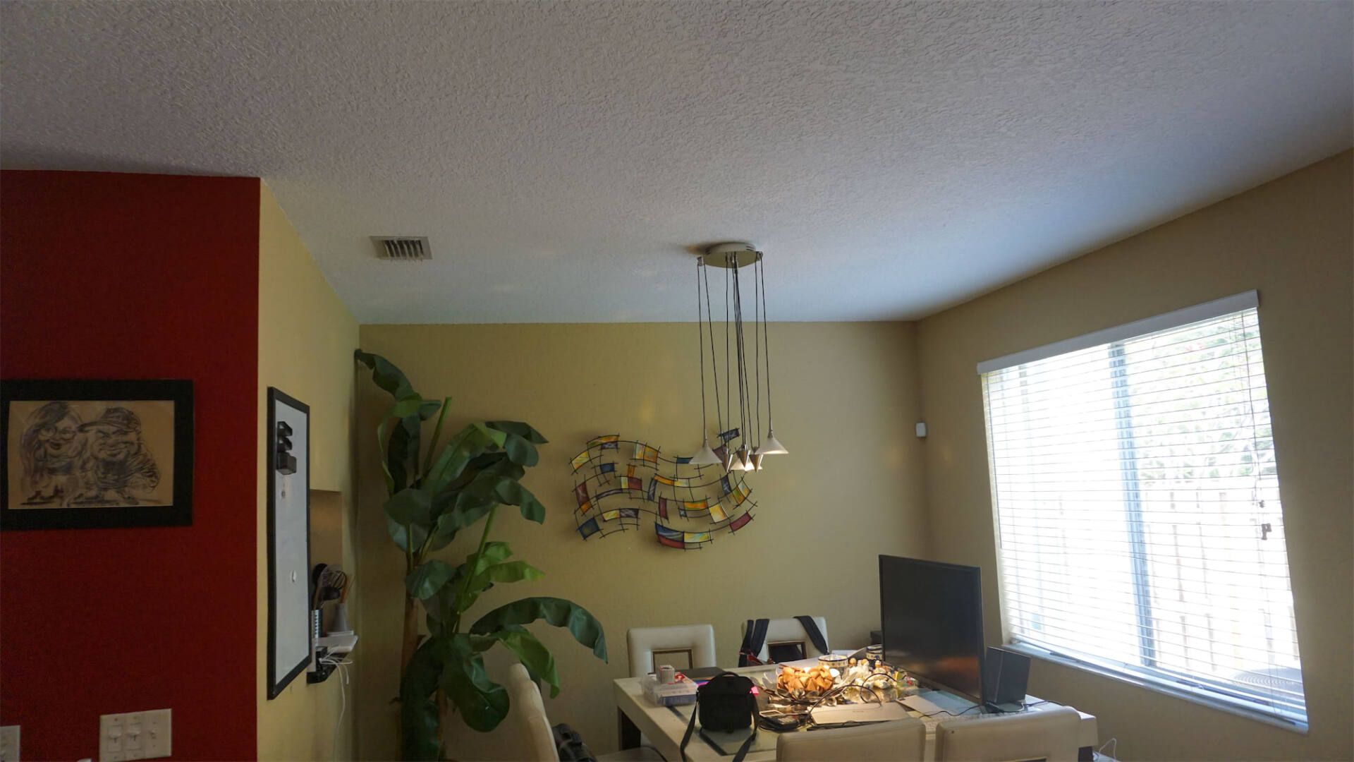 a dining room with a table and chairs and a television
