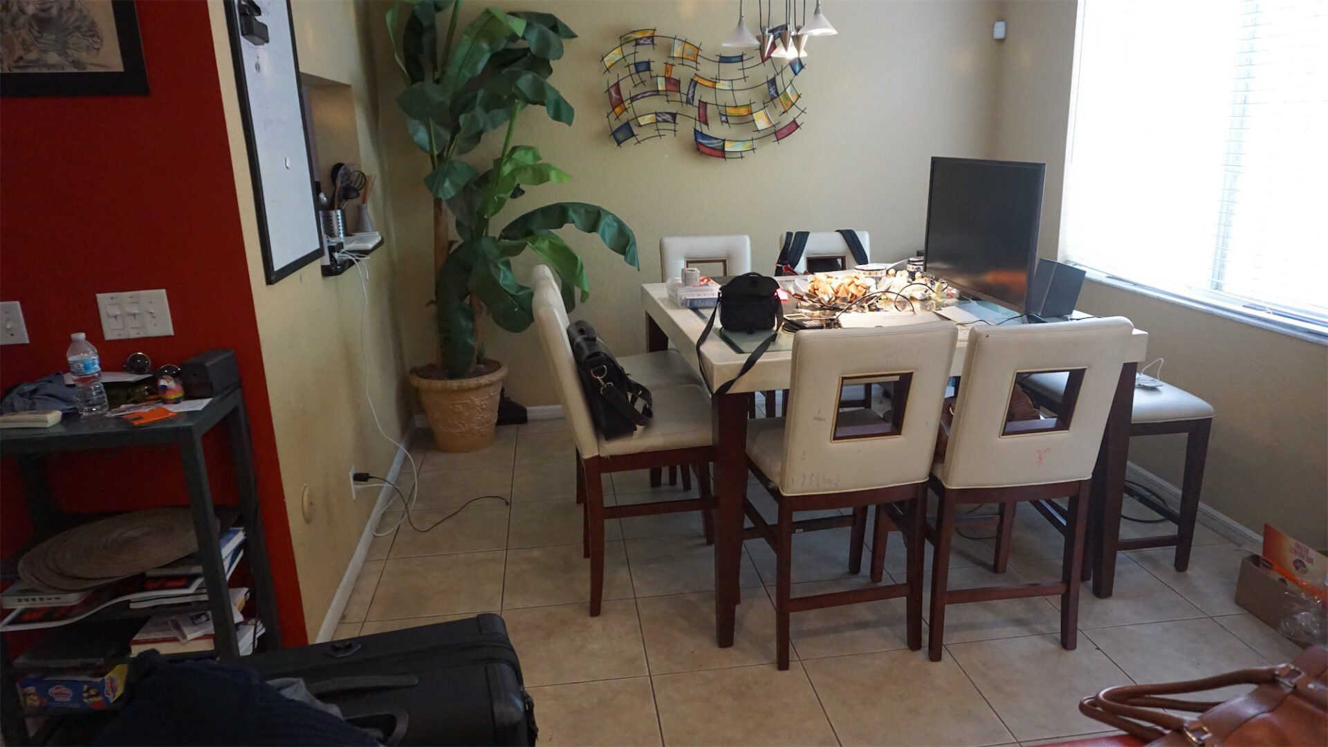 a dining room with a table and chairs and a plant