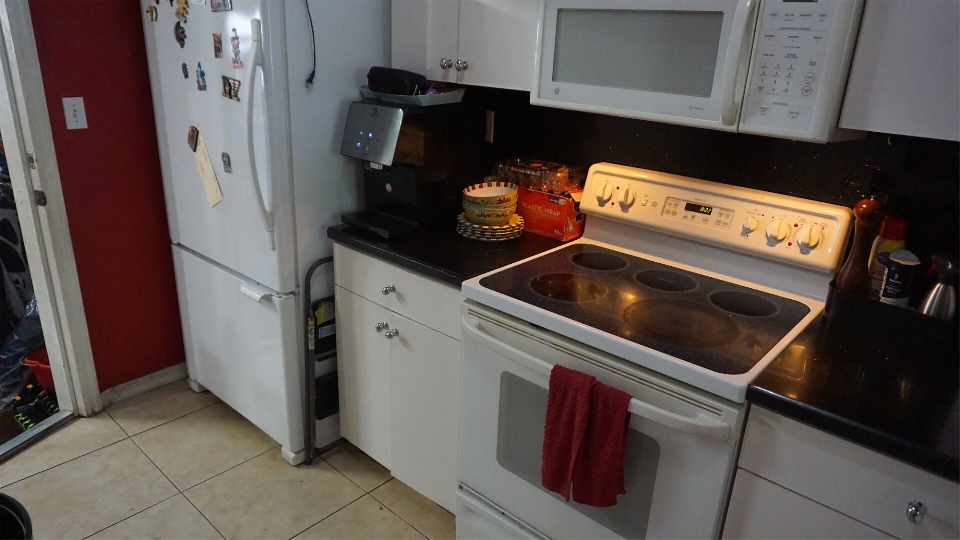 a kitchen with a stove , refrigerator and microwave
