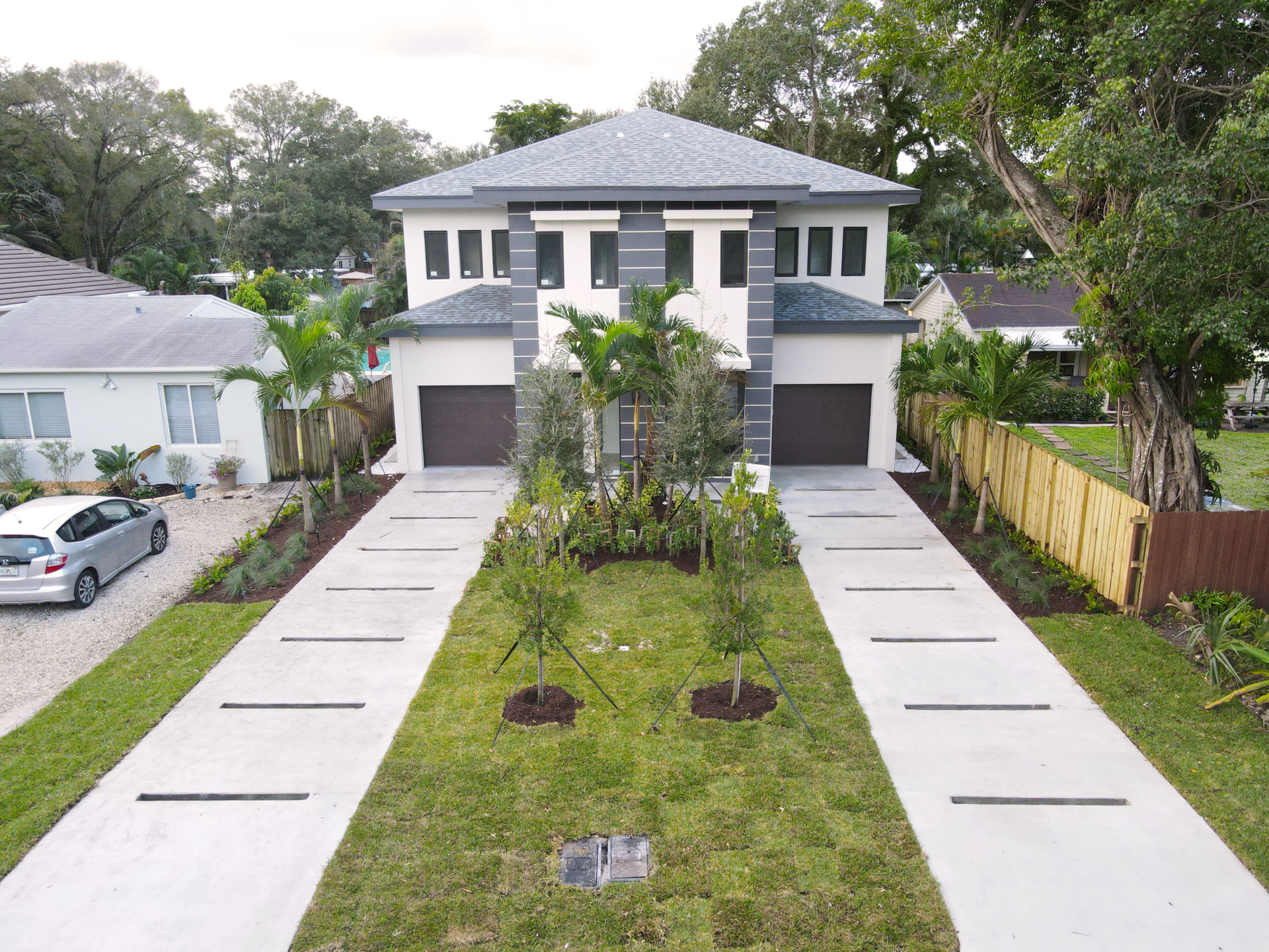 an aerial view of a house with a car parked in front of it .