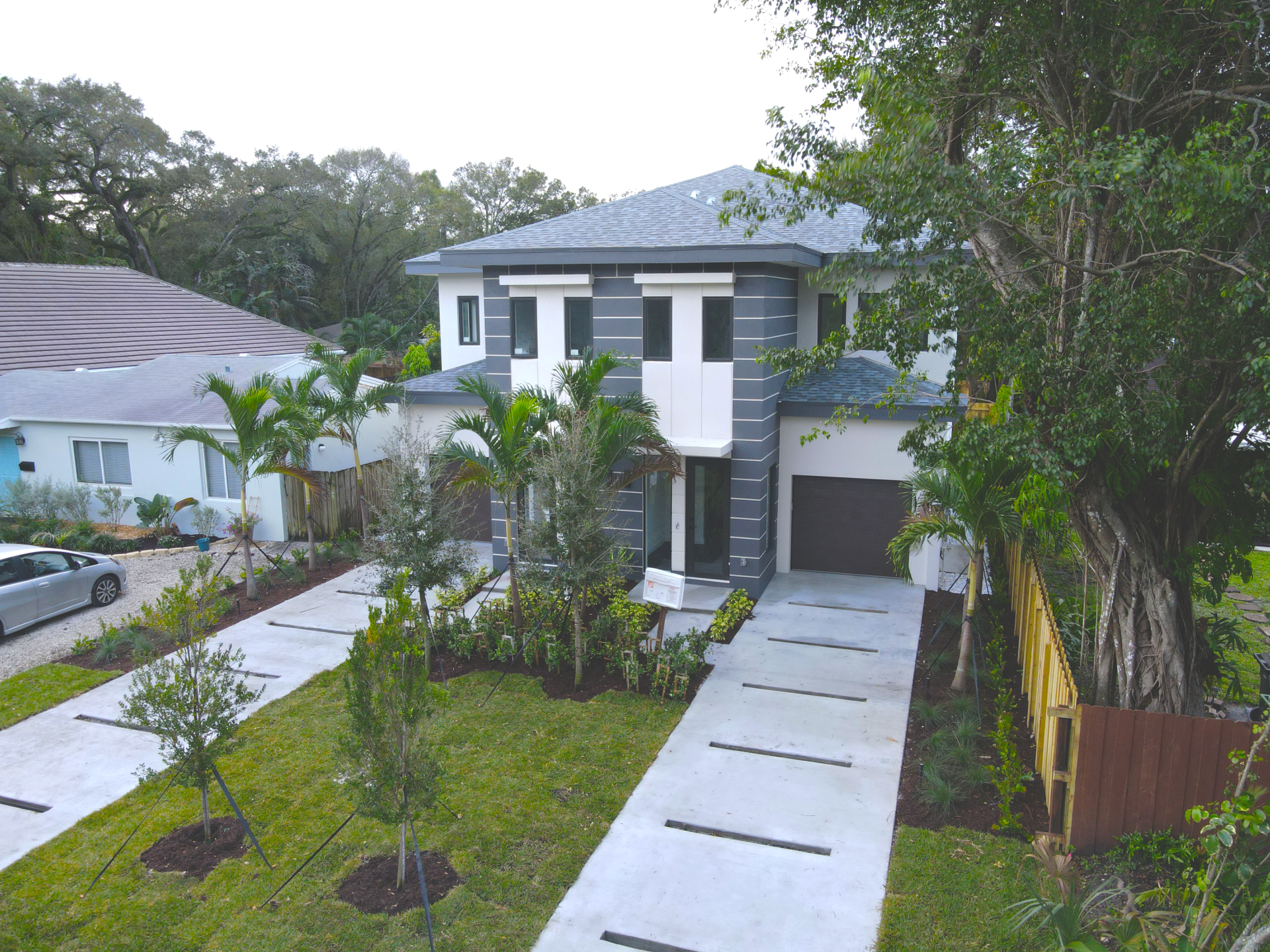 an aerial view of a house with a car parked in front of it