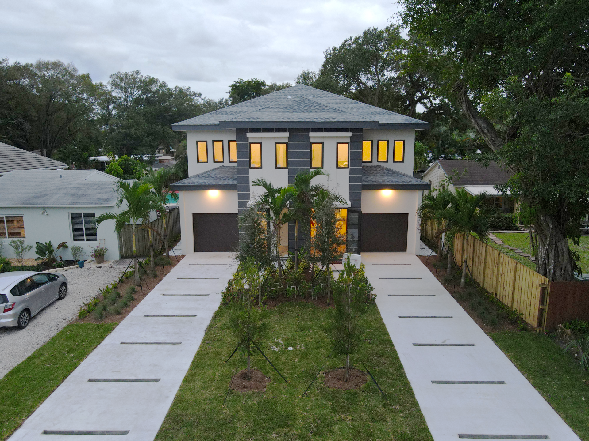 an aerial view of a house with a car parked in front of it
