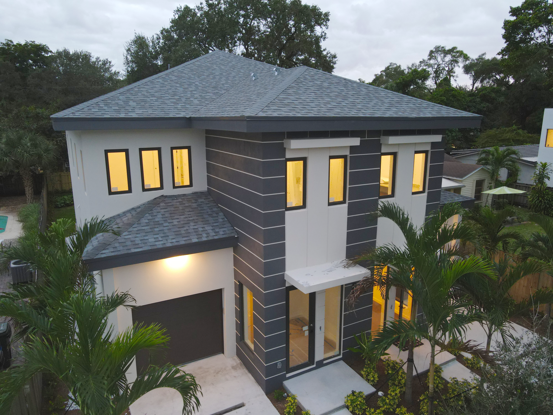 an aerial view of a house with a gray roof