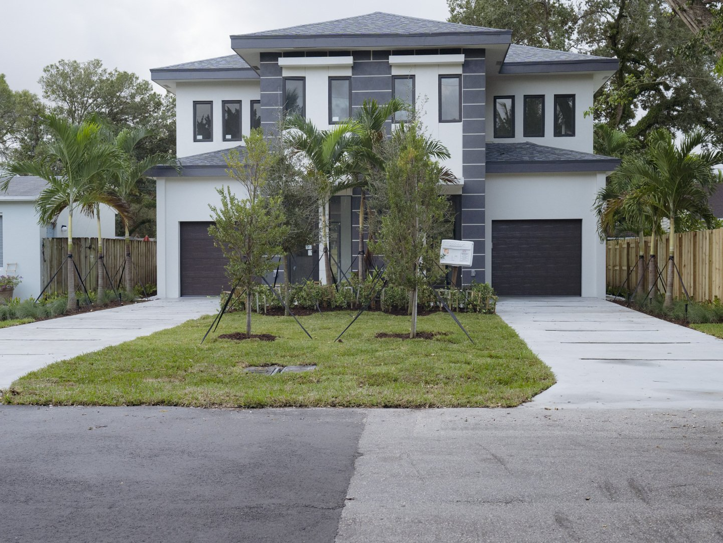 a house with a for sale sign in front of it