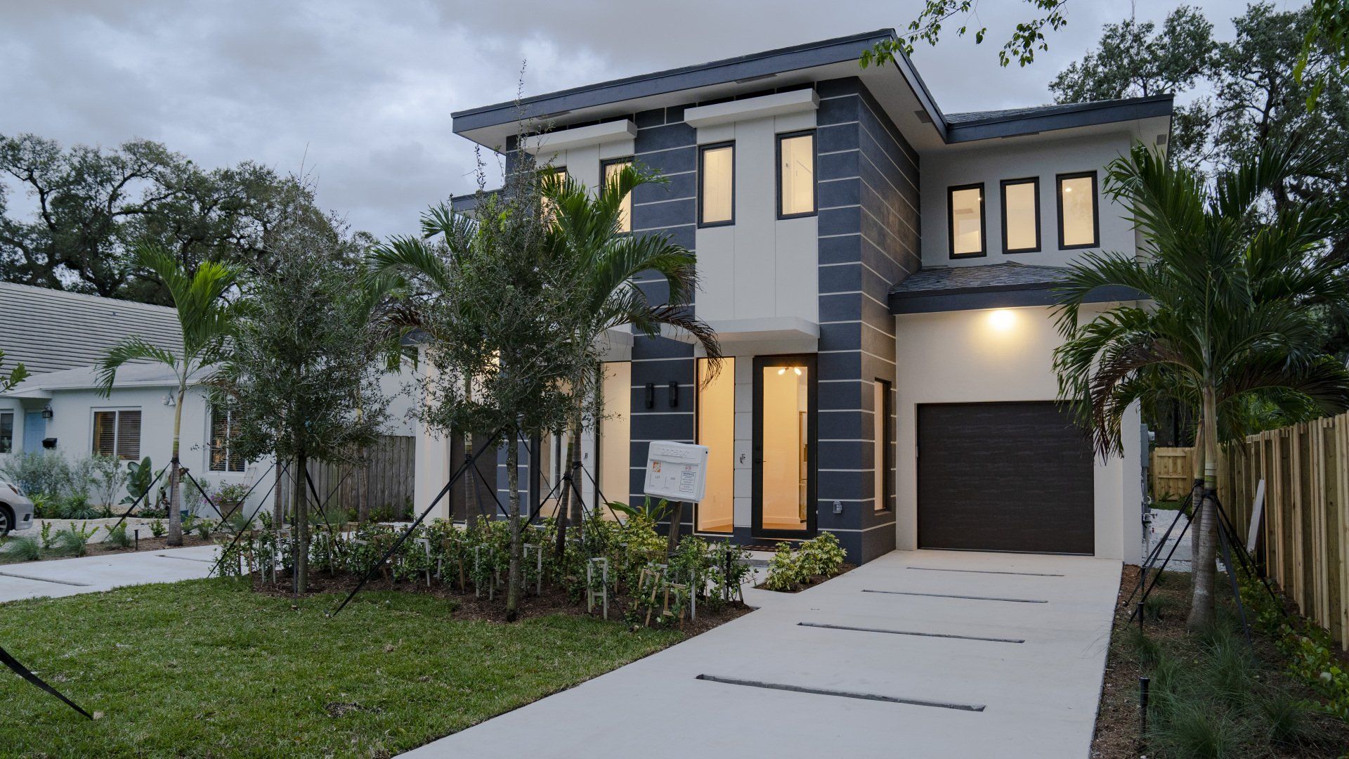 a black and white house with a black garage door