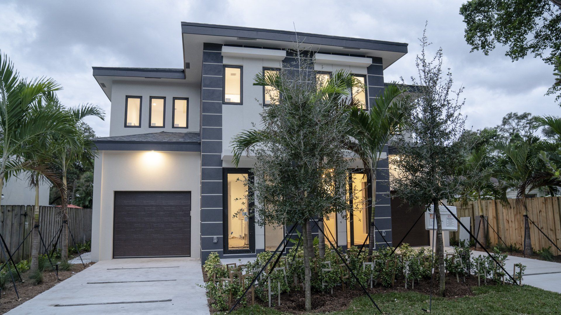 a modern house with a garage and lots of windows