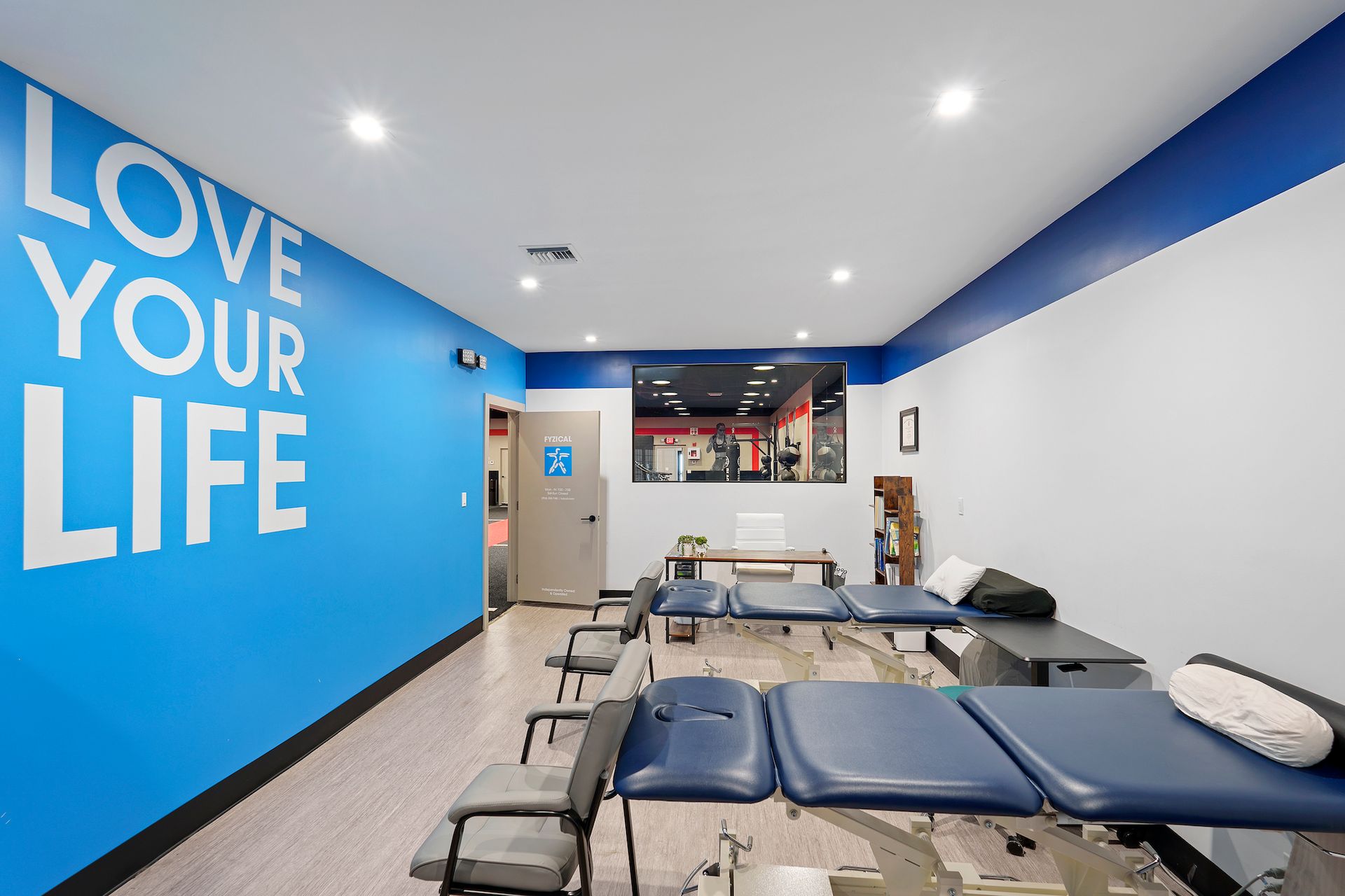 A room with a blue wall and a sign that says `` love your life ''.