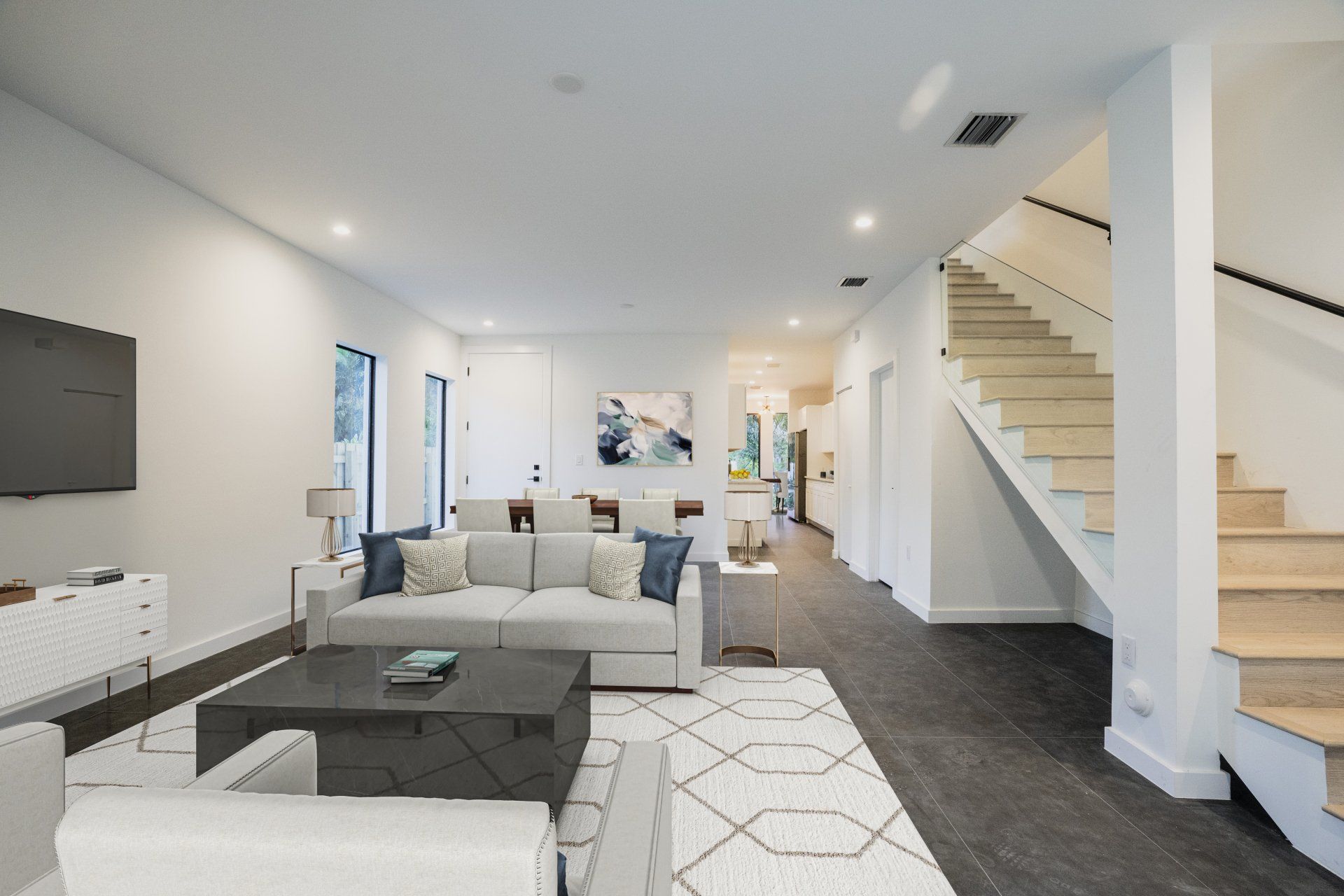 a living room with a couch and stairs in the background