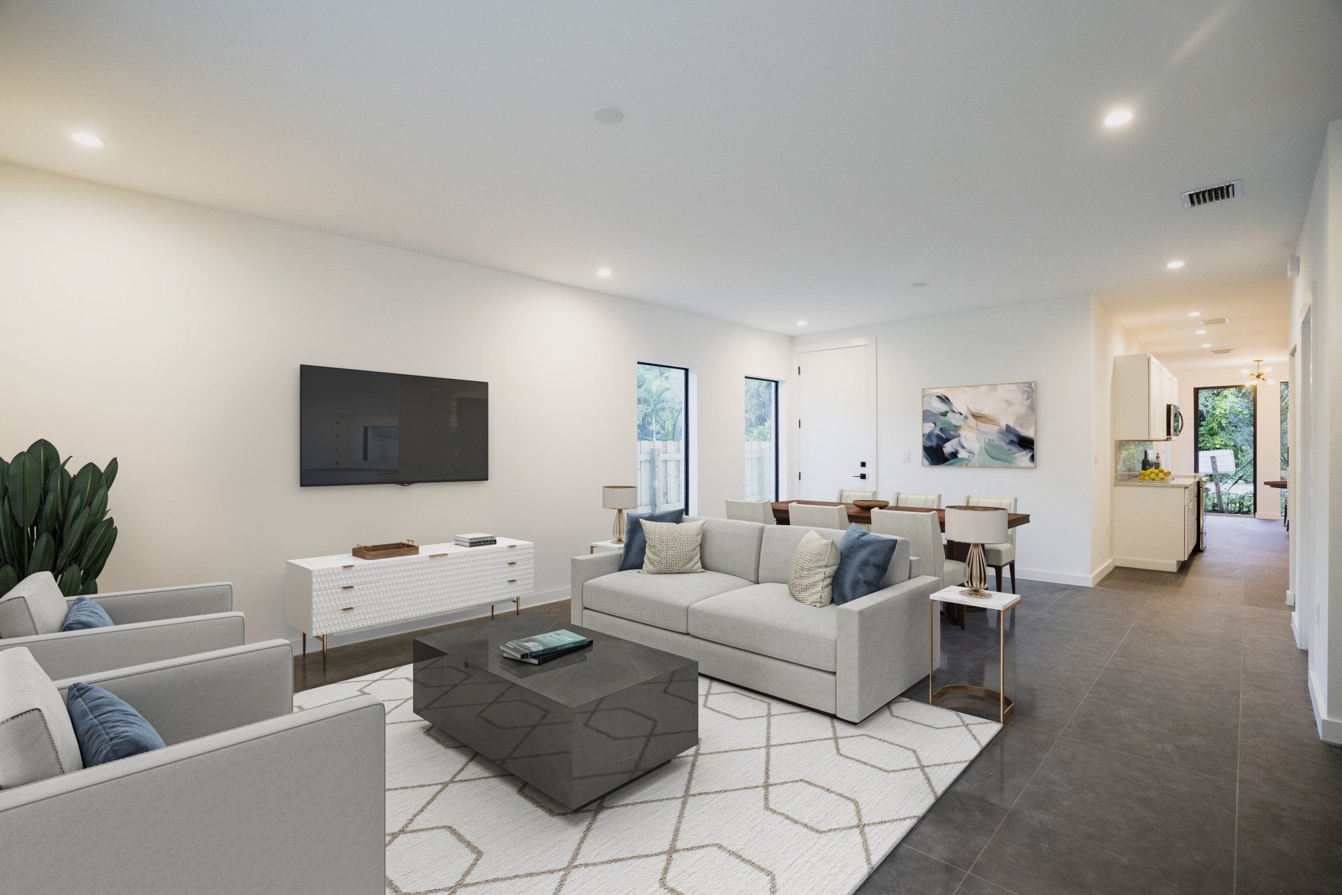 a living room with a couch , chairs , coffee table and television .