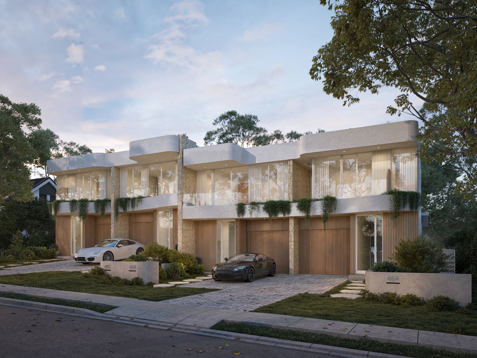 Modern white townhouses with light wood garage doors, cars parked in front — Gracia Building Design In Kiama, NSW
