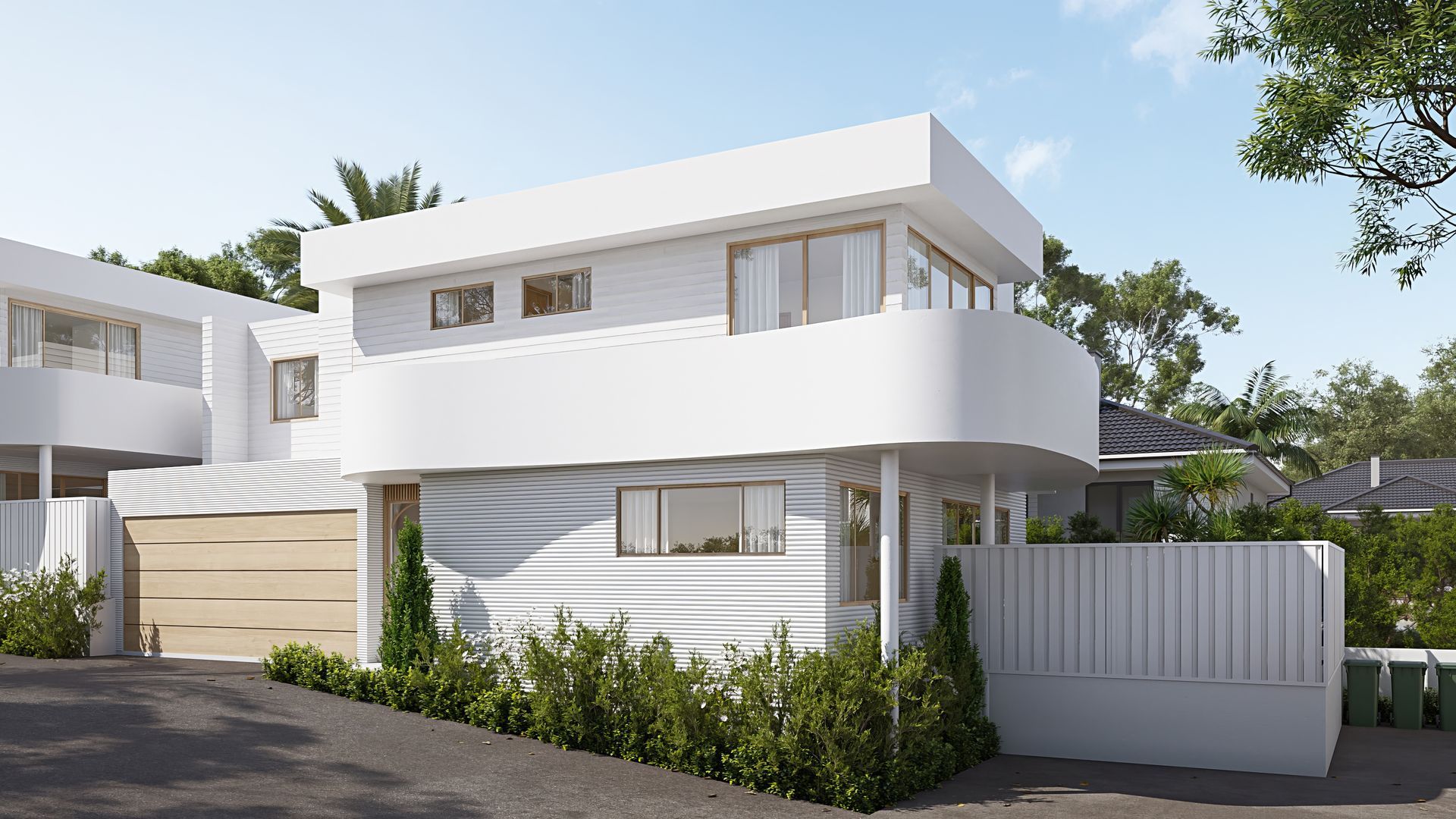 Modern white two-story house with balcony, front gate, and landscaped greenery under a blue sky — Gracia Building Design In Kiama, NSW