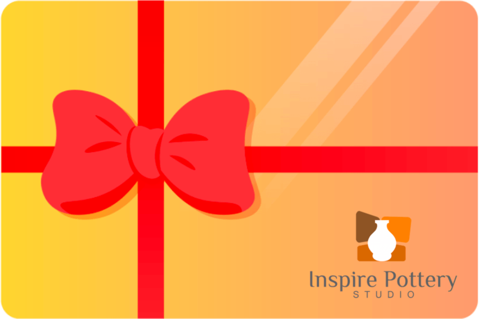 A gift card for inspire pottery studio with a red bow