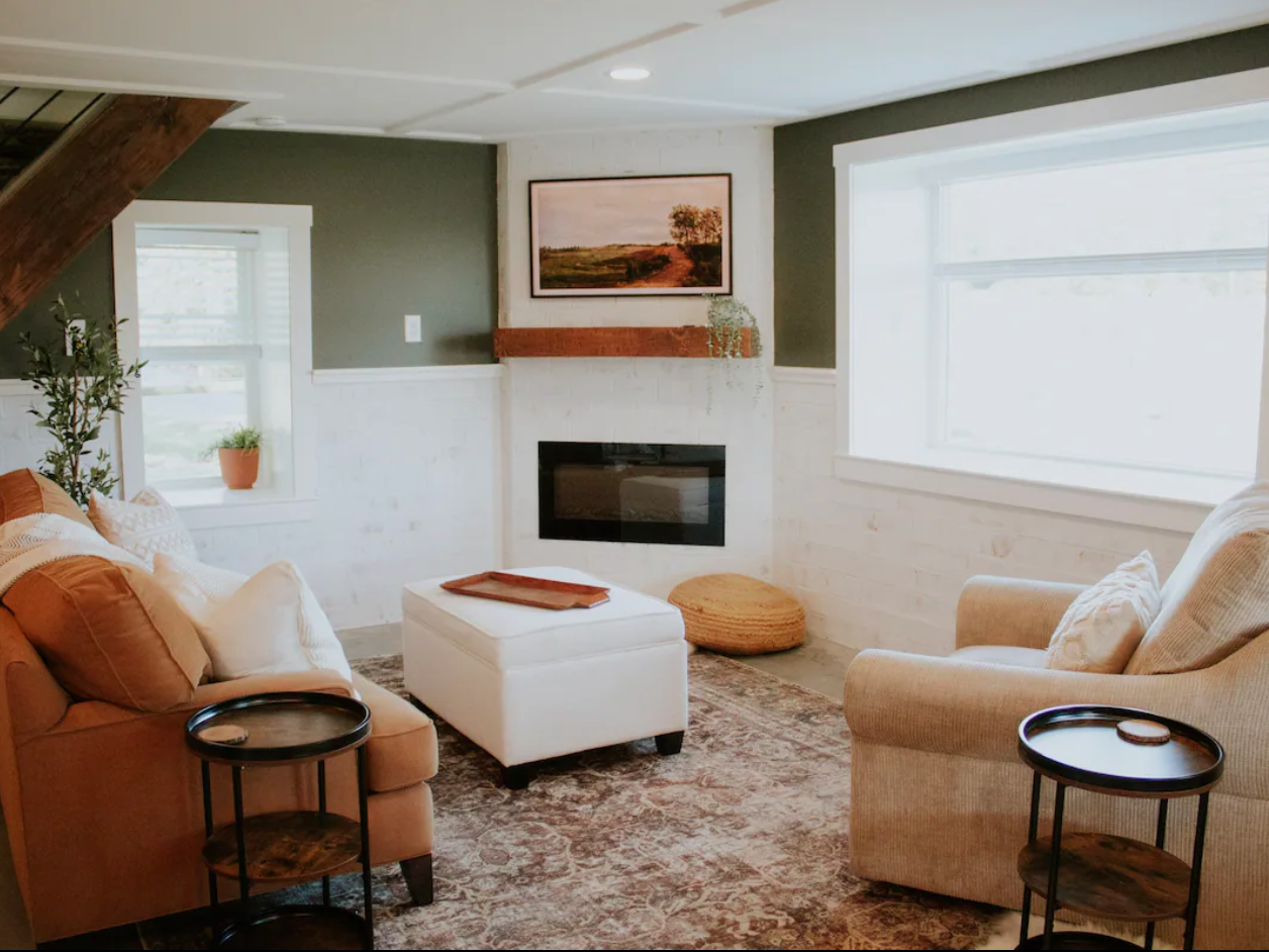 a living room with a fireplace and a painting on the wall