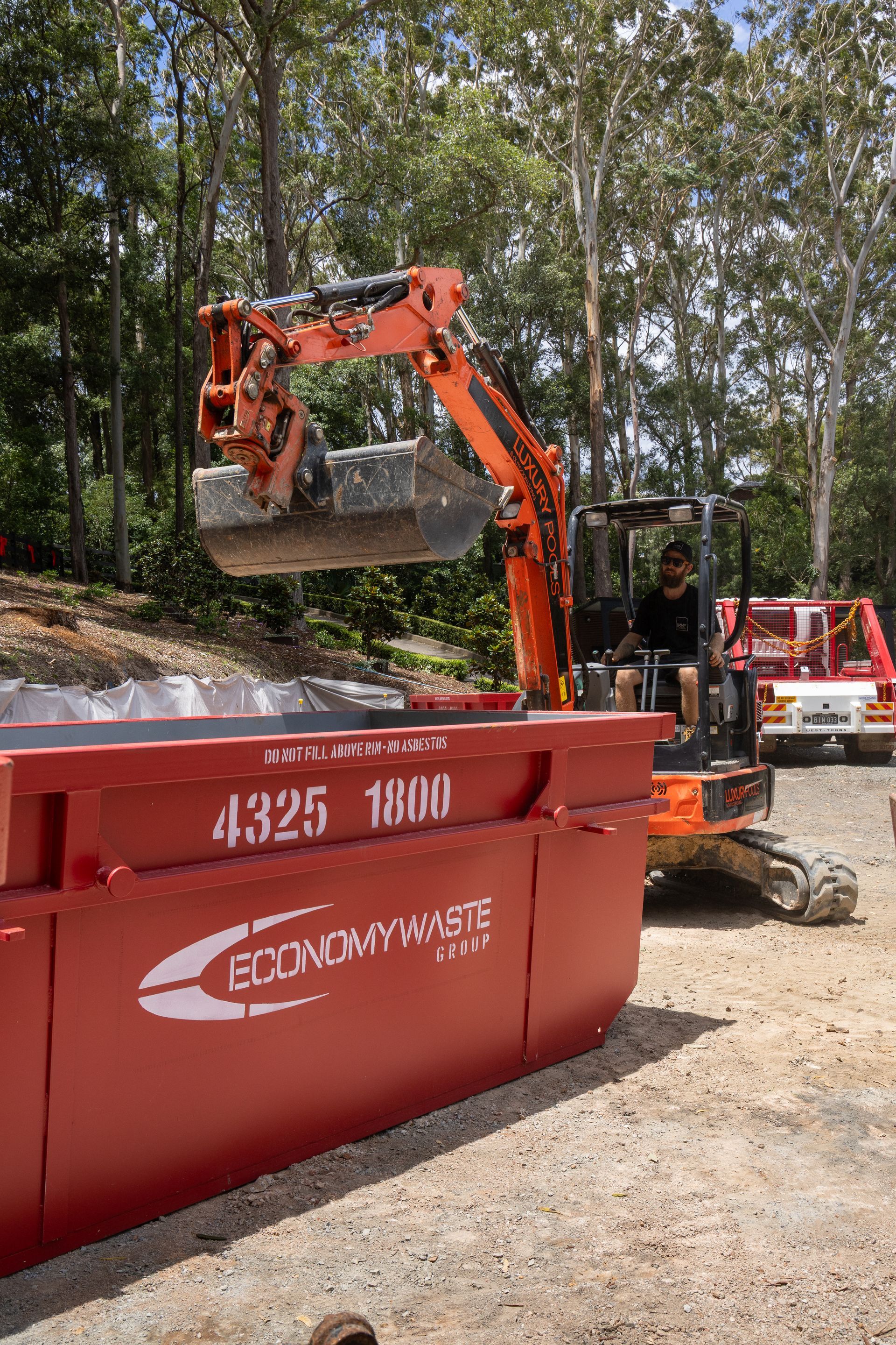 Truck Lifting a Large a Bin— Economy Waste Group | Skip Bins Central Coast In West Gosford, NSW