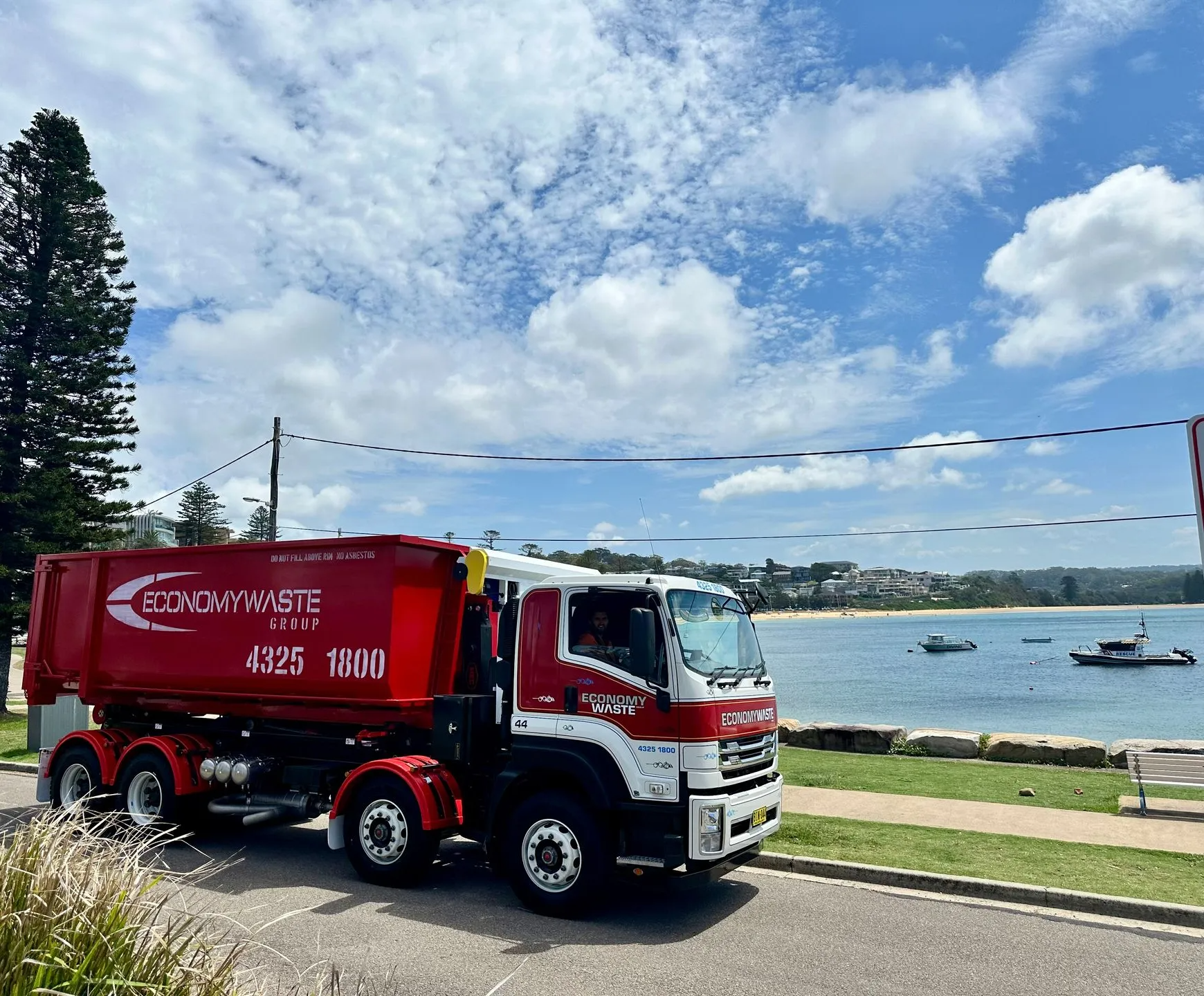 A Red and White Waste Truck — Economy Waste Group | Skip Bins Central Coast In Saratoga, NSW