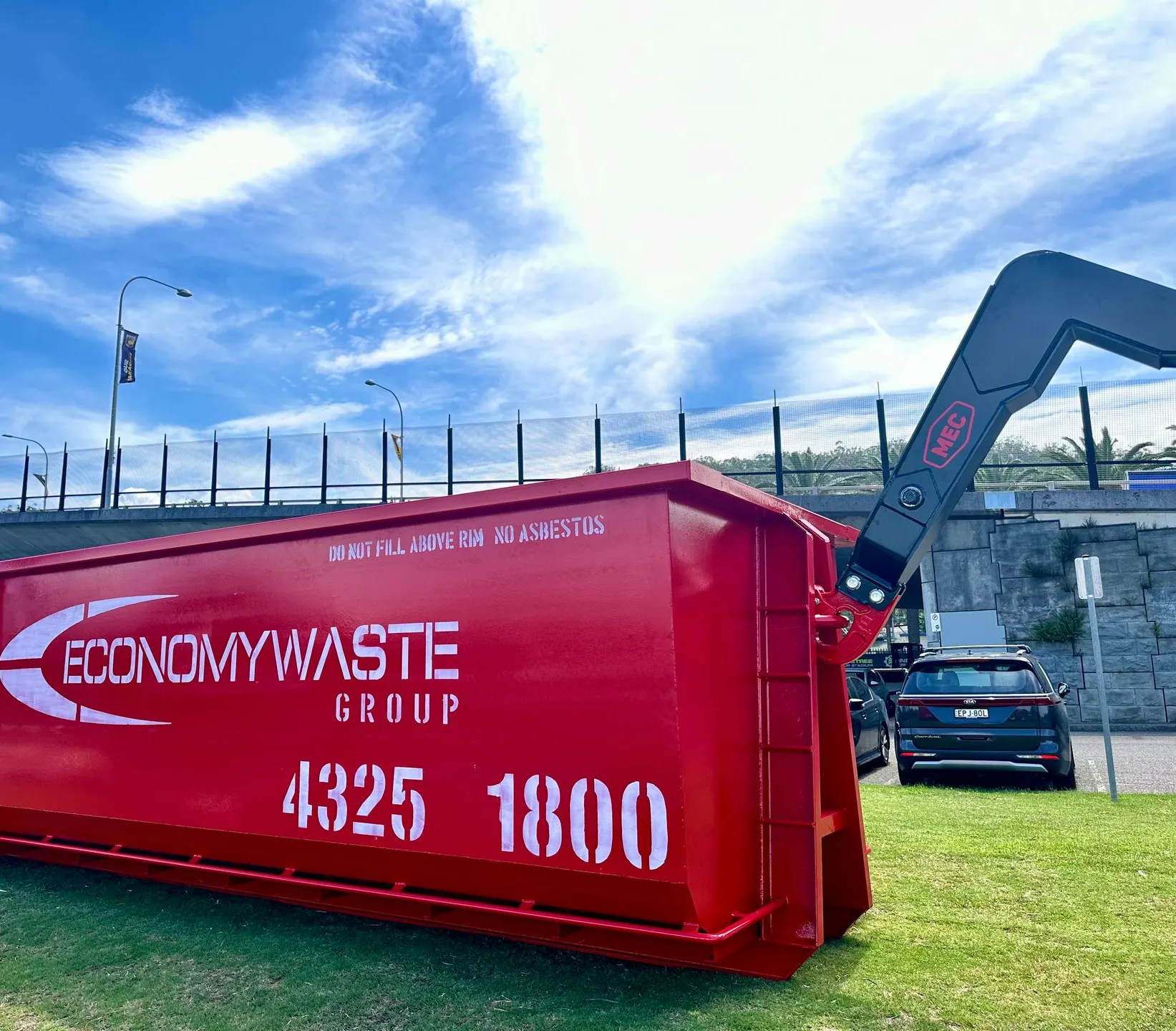 A Red Economy Waste Group Dumpster — Economy Waste Group | Skip Bins Central Coast In Mannering Park, NSW