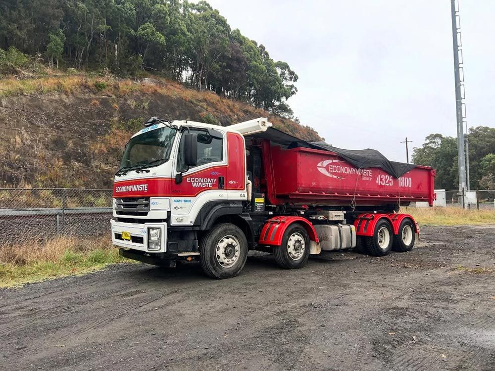 Truck with Skip Bin on The Road