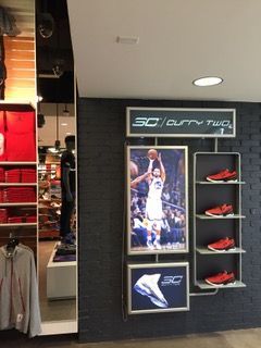 Shoe display featuring Stephen Curry, shoes, and a 