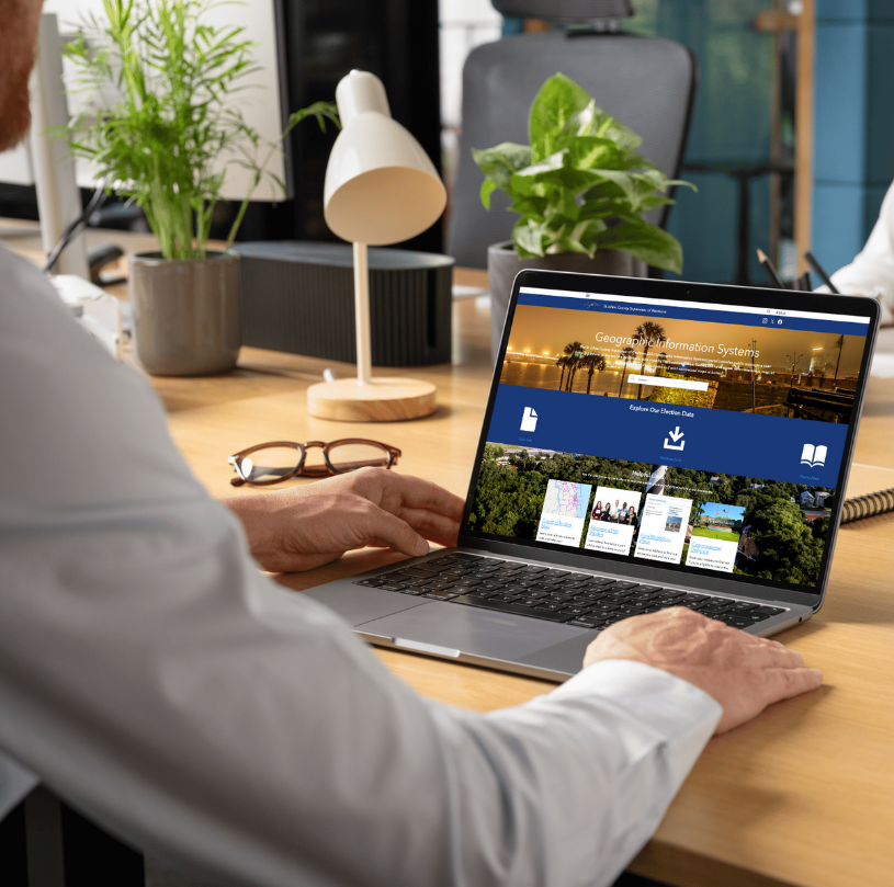 A laptop with the GIS Map Portal on the screen