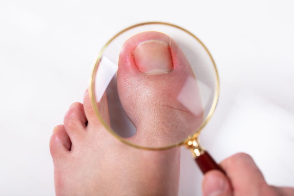 Overhead View of a Person Holding Magnifying Lense — Providing Diabetes Foot Assessments in Forster, NSW