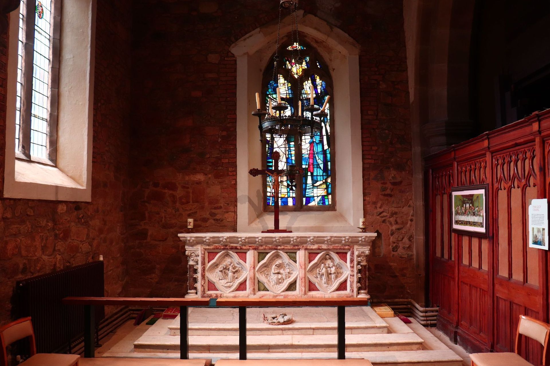 An altar in a church with a stained glass window st mary's atherstone warwickshire