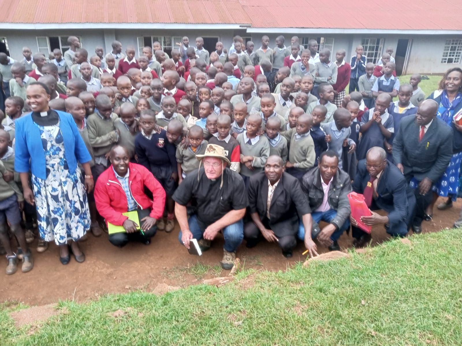 A large group of people are posing for a picture in front of a building.
