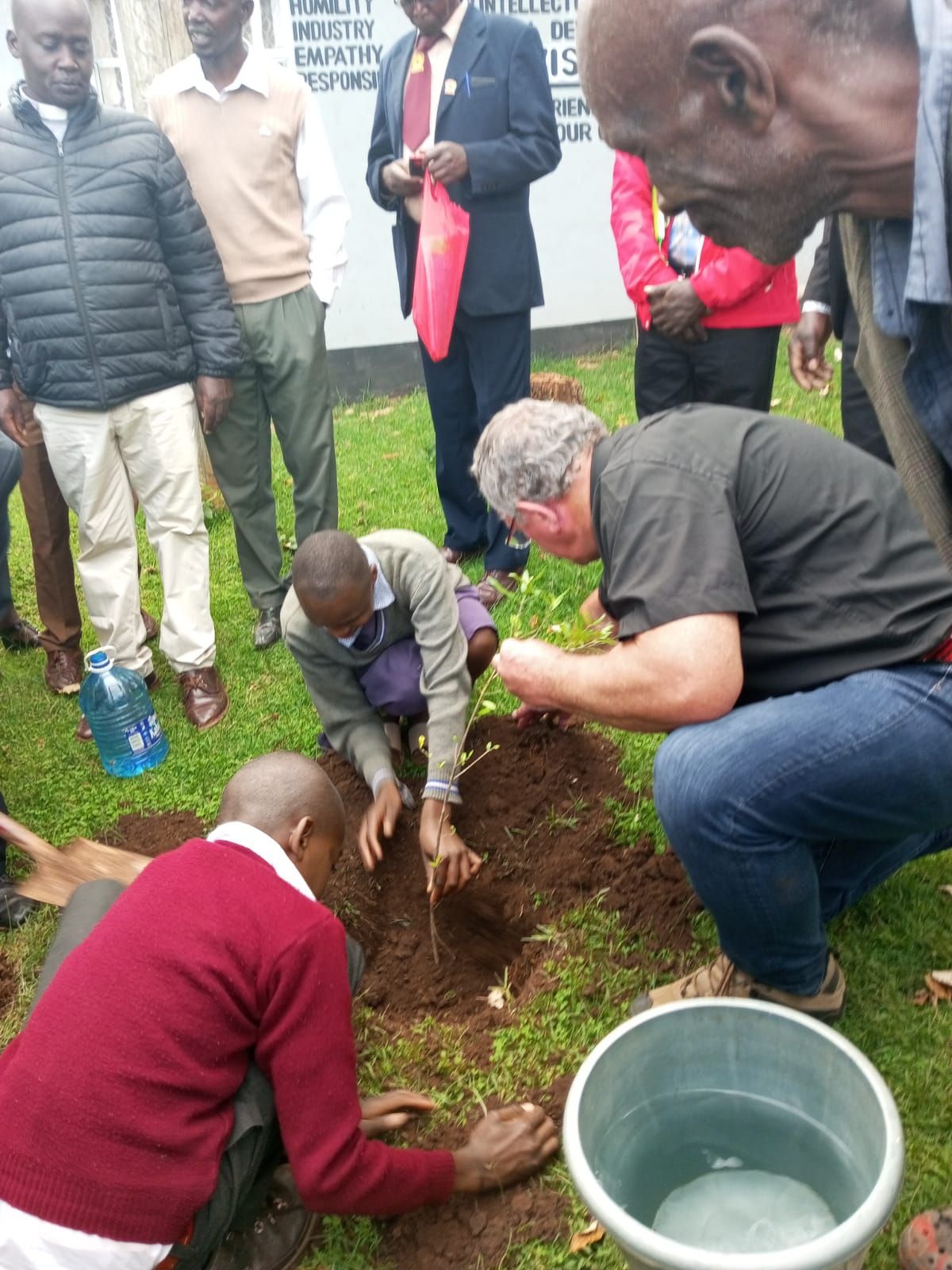 A group of men are digging a hole in the ground
