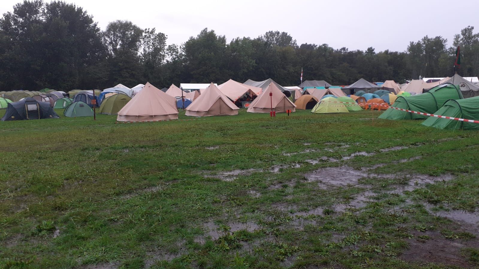A group of tents are sitting in a muddy field.
